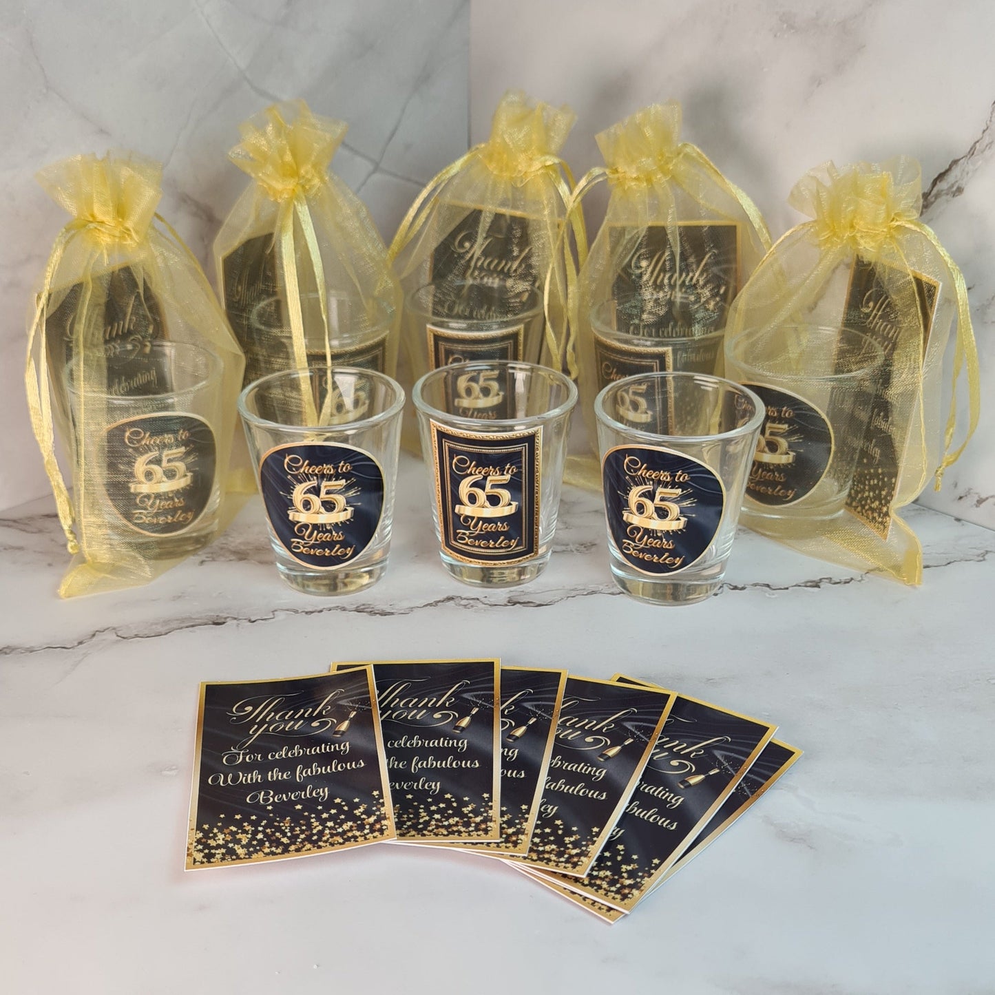 Set of shot glasses and decorative cards with personalized designs for any event . 